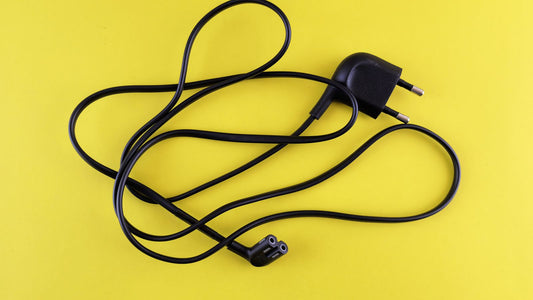 A complete lamp cord set laid flat, showing the wall plug at one end and the appliance connector at the other