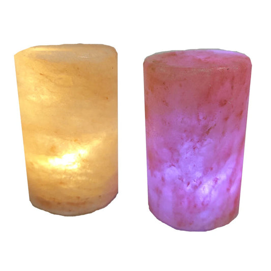 Two cylindrical Himalayan salt lamps lit from within, showing the pitted texture of the salt surface